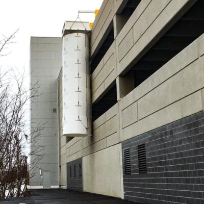 Small Superchute snow chute installed on a parkade.