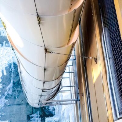 Top down view of a Superchute snow chute installed on a parking garage.